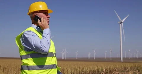 Engineer Walk and Talk to Mobile Technical Issues Wind Turbines Generators Stock Footage 83657293