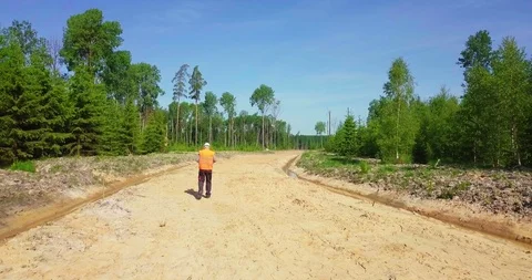 Engineer walking away on the new forest road Stock Footage 90570451
