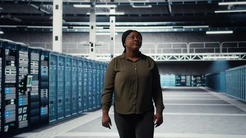Engineer walking in data center, checking hardware for system stability Stock Photos