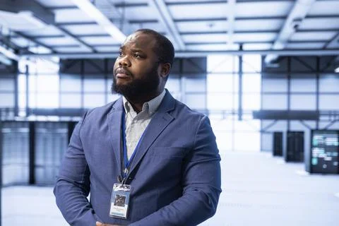 Engineer walking in data center, configuring network infrastructure Stock Photos