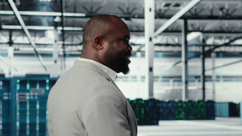 Engineer walking in data center facility, doing inspection on hardware tech Stock Footage 311832850