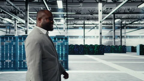 Engineer walking in data center facility, doing inspection on hardware tech Stock Footage 311898178