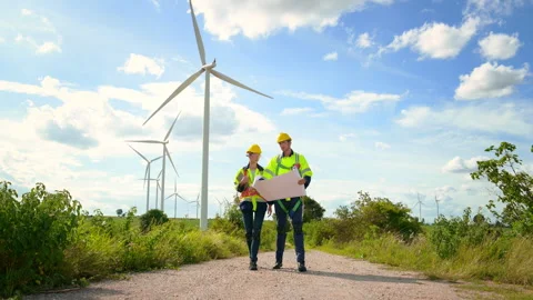 Engineer is walking in a field wearing a protective helmet on  head Stock Footage 269098317
