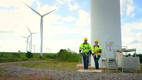 Engineer is walking in a field wearing a protective helmet on  head Stock Footage 269098713