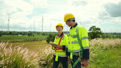 Engineer is walking in a field wearing a protective helmet on  head Stock Footage 269099089