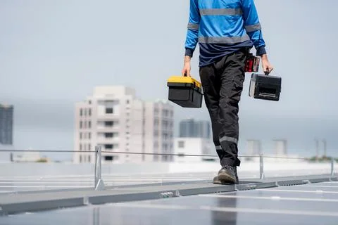 Engineer walking inspection solar panel installation on rooftop, checking p.. 写真素材