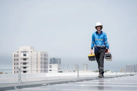 Engineer walking inspection solar panel installation on rooftop, checking p.. 写真素材