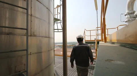 Engineer walking in refinery plant Stock Footage 34357113