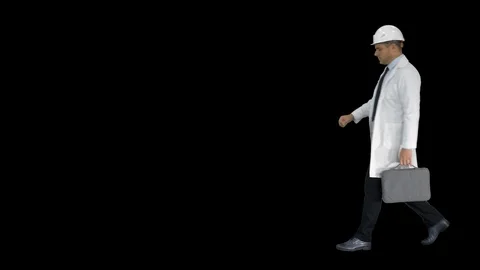 Engineer walking in a rush and looking at his watch, Alpha Channel Vídeos de archivo 115529318