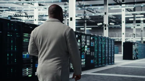 Engineer walking in server farm, automating system diagnostics Stock Footage 311833676