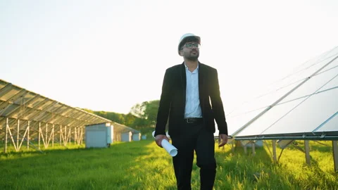 Engineer walking in solar panel farm at sunset Stock Footage 314408478