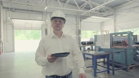 Engineer walking through manufacturing plant Stock Footage 66244175