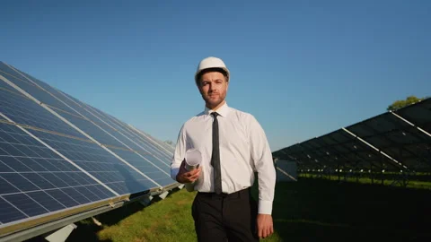 Engineer walking through solar station, inspecting installation Stock Footage 296848285