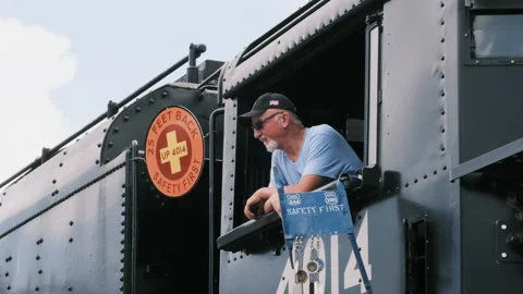 Engineer waves from cab of Union Pacific Big Boy steam engine 4104. Stock Footage 162542798