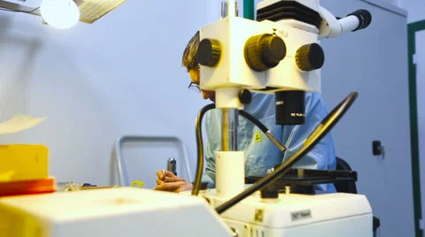 Engineer Wearing Eyeglasses Near the Microscope Close up Stock Footage 60583112