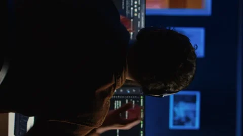Engineer wearing headphones while using coding to fortify IT security Stock Footage 265107405