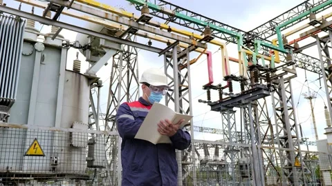 Engineer wearing protective mask against Covid-19 working on checking equipment Stock-Footage 130920527