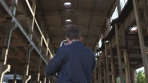 Engineer wearing a protective mask put on a white helmet at a hazardous facility Stock Footage 138494566
