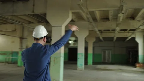 An engineer wearing virtual reality glasses moves digital objects with his hands Stock Footage 152754737
