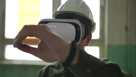An engineer wearing virtual reality glasses moves digital objects with his hands Stock Footage 152755780