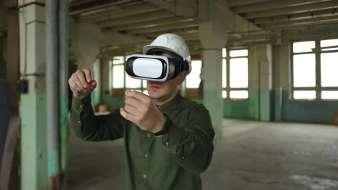 An engineer wearing virtual reality glasses moves digital objects with his hands Stock Footage 152755966