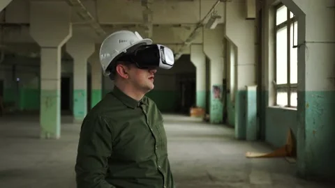 An engineer wearing virtual reality glasses moves digital objects with his hands Stock Footage 152756173