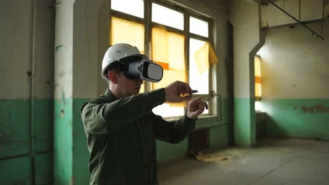An engineer wearing virtual reality glasses moves digital objects with his hands Stock Footage 152756286