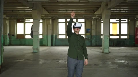 An engineer wearing virtual reality glasses moves digital objects with his hands Stock Footage 152756559