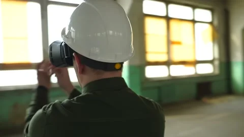 An engineer wearing virtual reality glasses moves digital objects with his hands Stock Footage 152756657