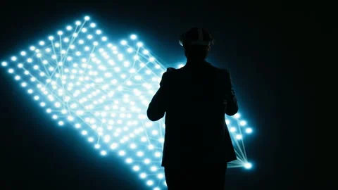 Engineer wearing VR headset gear to look at glowing AI neural network Stock Footage 329720711