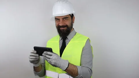 Engineer wearing work helmet holding smartphone doing thumb up Stock Footage 152626798