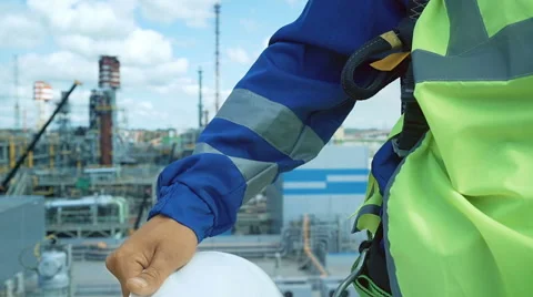 Engineer with white hardhat. Indusrtial background with blue sky Video stock 67718919