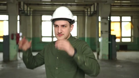 An engineer in a white helmet shows a thumb up. smiling at the work site Stock Footage 152723503