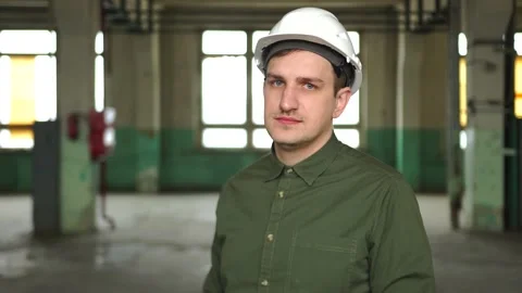 An engineer in a white helmet shows a thumb up. smiling at the work site Stock Footage 152723573