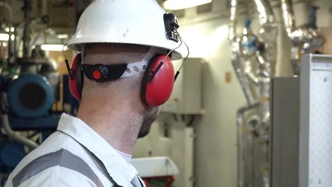 Engineer in a white workwear stands in a production workshop. Stock Footage 120516954