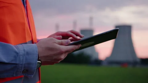 Engineer who prints a report on the operation of a power plant on a tablet Stock Footage 234589297