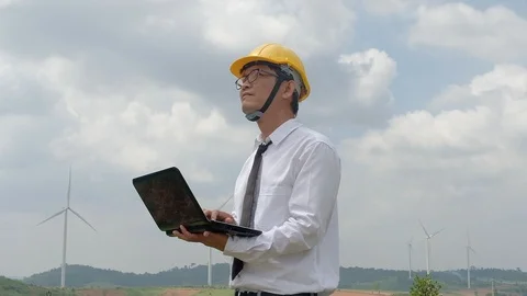 Engineer at windmill power plant with notebook computer in hand. Stock Footage 116489729