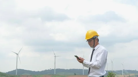 Engineer at windmill power plant with smartphone in hand. Stock Footage 116490669