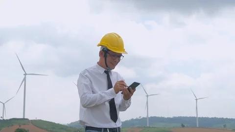 Engineer at windmill power plant with smartphone in hand. Slow motion Stock Footage 116555740