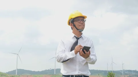 Engineer at windmill power plant with smartphone in hand. Stock Footage 117502309