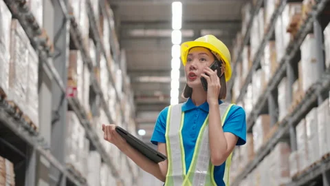 Engineer woman checking supplies and talking to someone with cellphone. Stock Footage 218876252