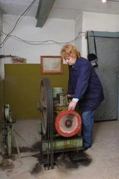 Engineer woman  in machine room (elevator). Stock Photos