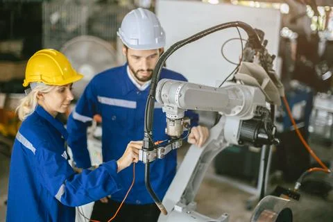 Engineer woman team worker work in Machine Robotic modern Automation Indust.. Stock Photos