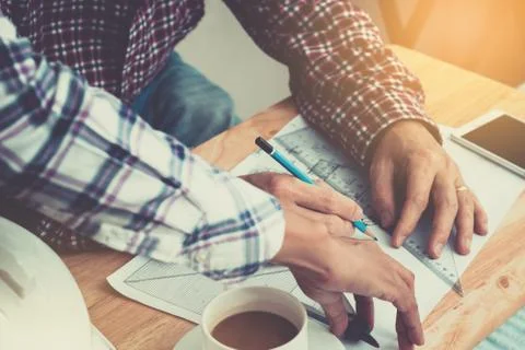 An engineer work for architectural project.With a cup of coffee,tools,drawing Stock Photos