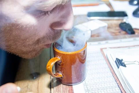 Engineer at work drinking cup of coffee Stock Photos