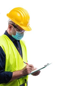 Engineer at work protects the face with the surgical mask. Construction indus Stock Photos