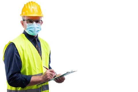 Engineer at work protects the face with the surgical mask. Construction indus Stock Photos