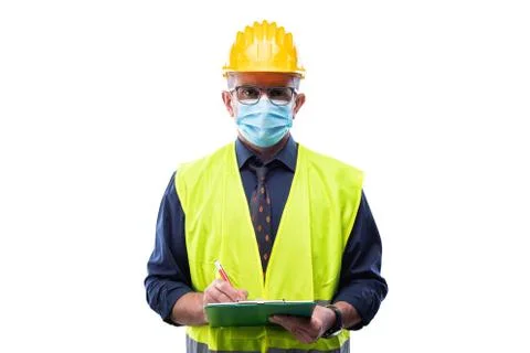 Engineer at work protects the face with the surgical mask. Construction indus Stock Photos