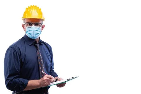 Engineer at work protects the face with the surgical mask. Construction indus Stock Photos
