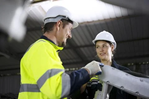 Engineer work at robotic arm factory. Stock Photos